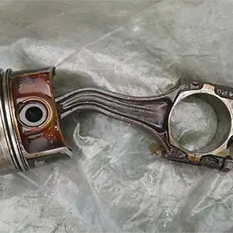 Failed piston and connecting rod assembly inspected during mechanical engine assessment
